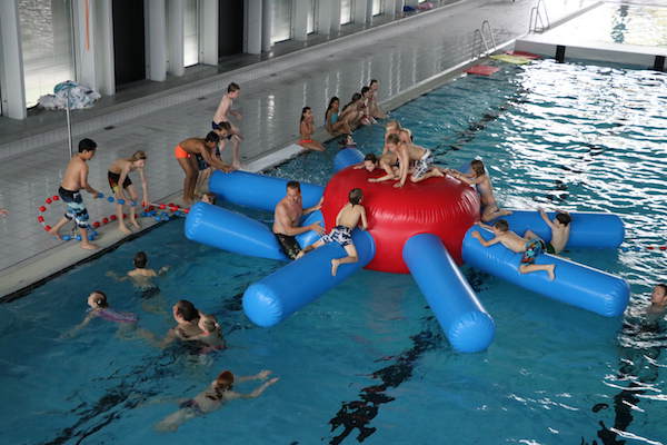 Kinderen spelen op kussen in het water