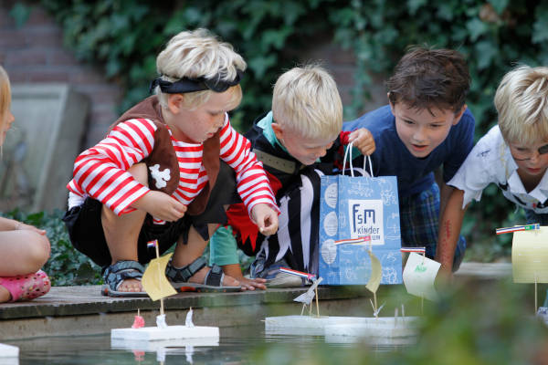 Kinderen spelen bij de vijver